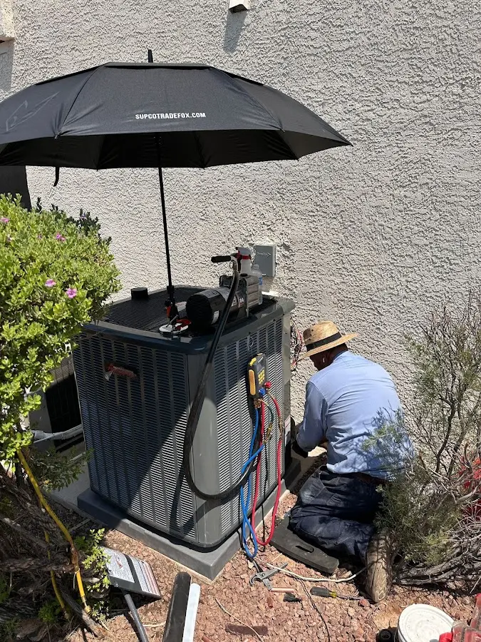 HVAC technician performing outdoor AC maintenance in Headland